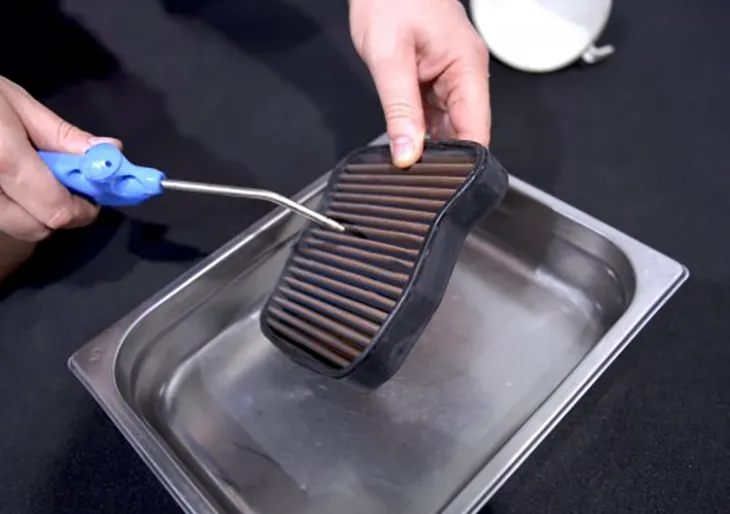 Cleaning a SprintFilter air filter with water and compressed air.