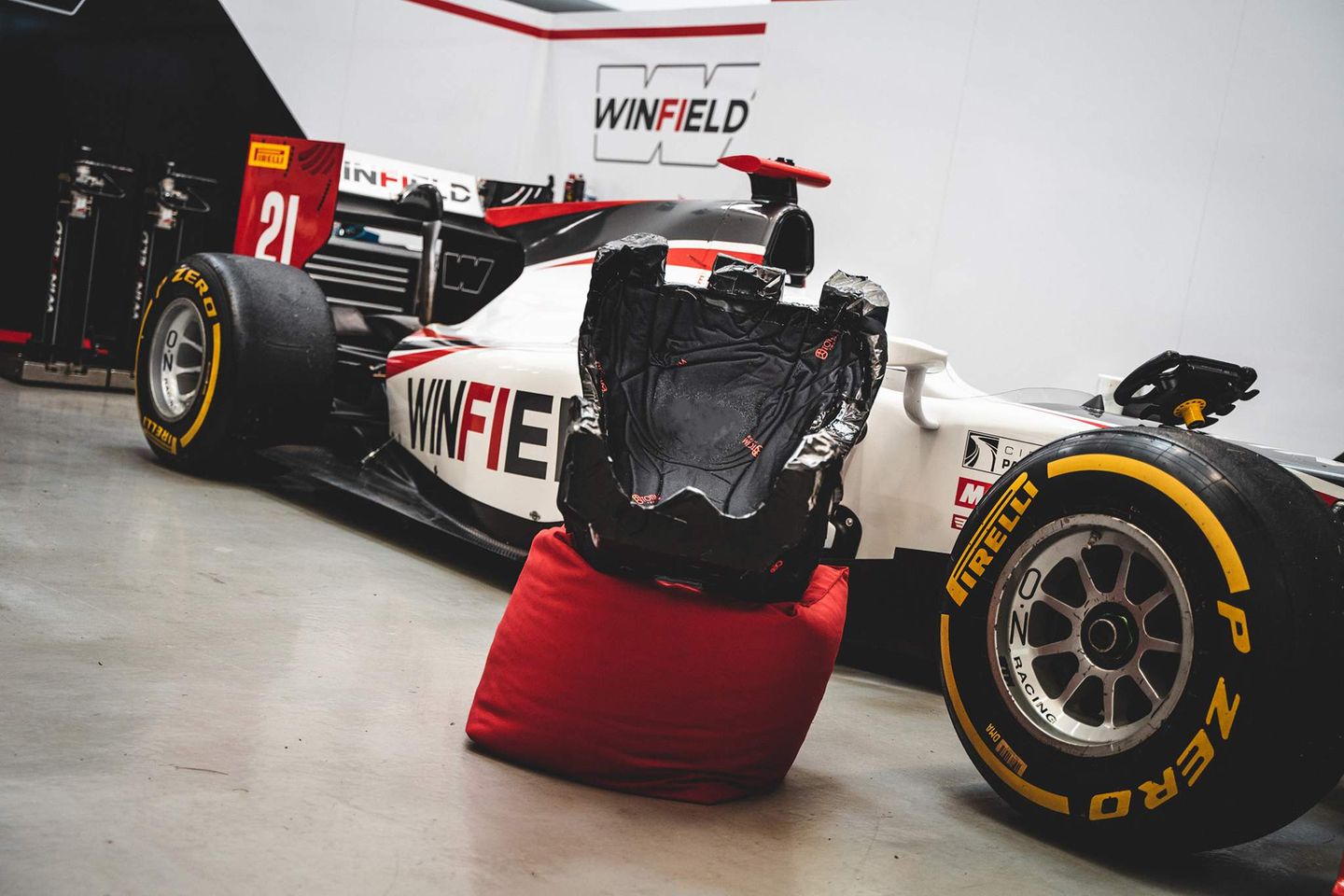 Totim racing car seat presented in front of a racing car